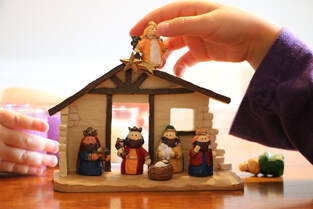 Picture of children setting up a nativity scene